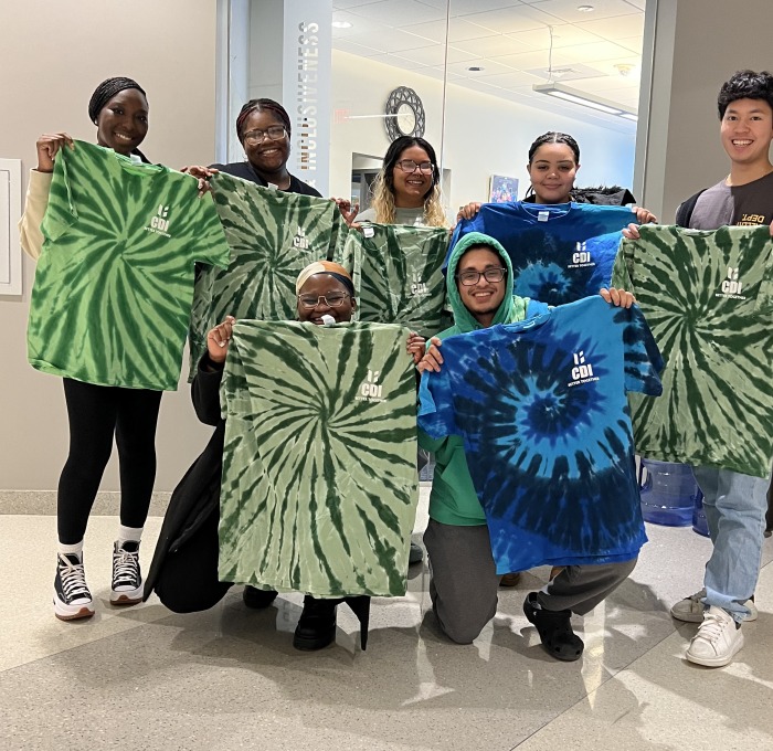 CDI group with tie dye t-shirts in front of office in Hammond