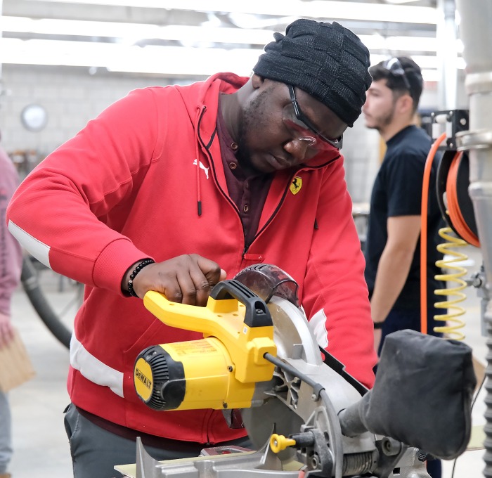 Student working on saw in design and fabrication class