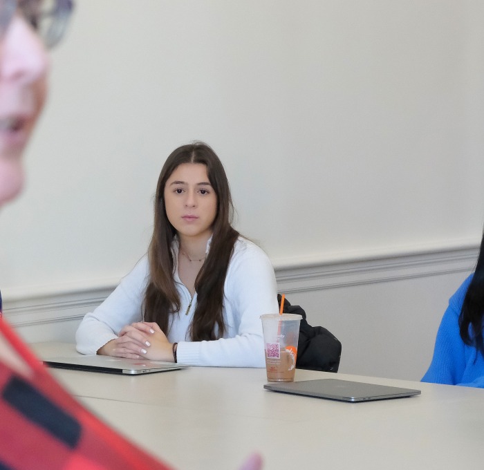 Closeup of Kisha Tracy lecturing and students at table in a classroom