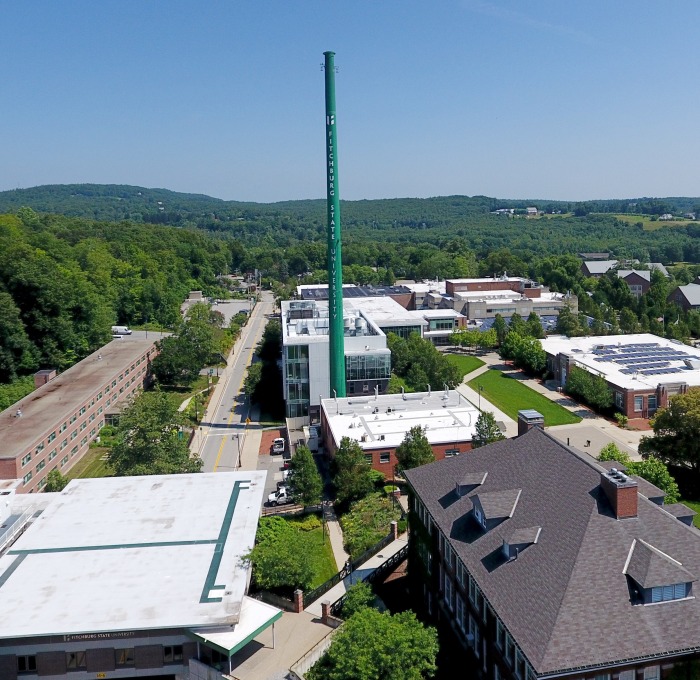 Aerial view of the smokestack and tops of buildings on campus