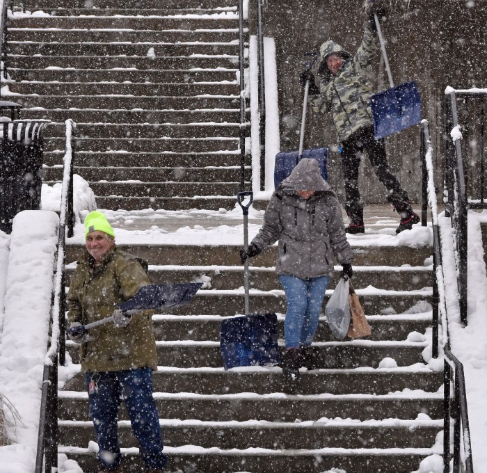 Maintainers shoveling snow on the stairs