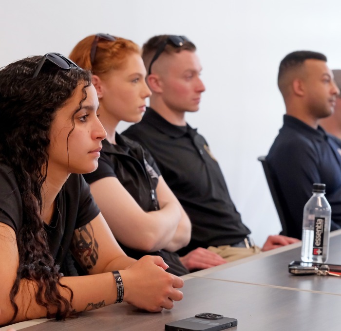 3 male 2 female CJ students in a classroom listening to a lecture