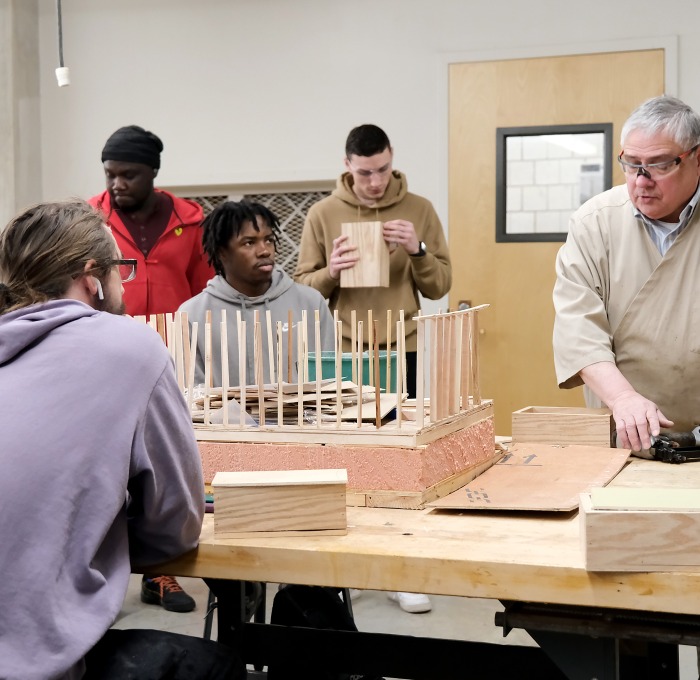 Wayne Whitfield and students building a model in classroom