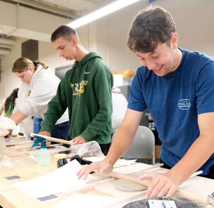 Students working with clay in ceramics class