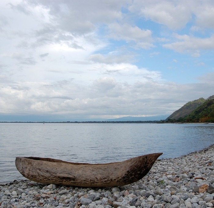 Lake Mawali in Africa with wood boat on rocky shore