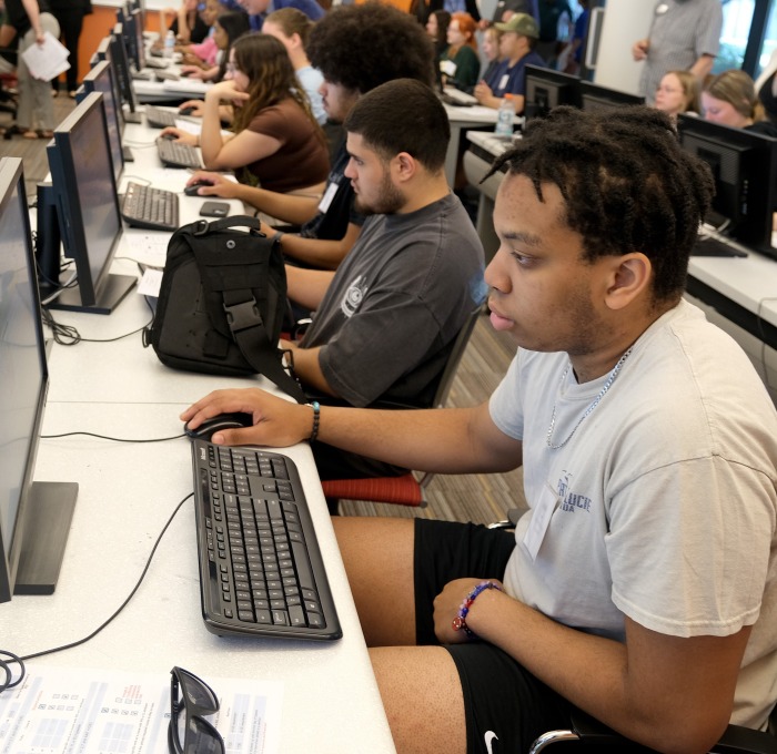 Tables of students all working at desktop computers