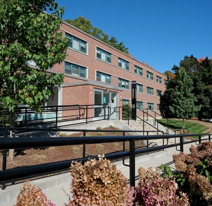 Exterior of Herlihy Hall with ramp trees and bushes
