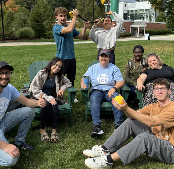Group of students sitting on the quad with games.