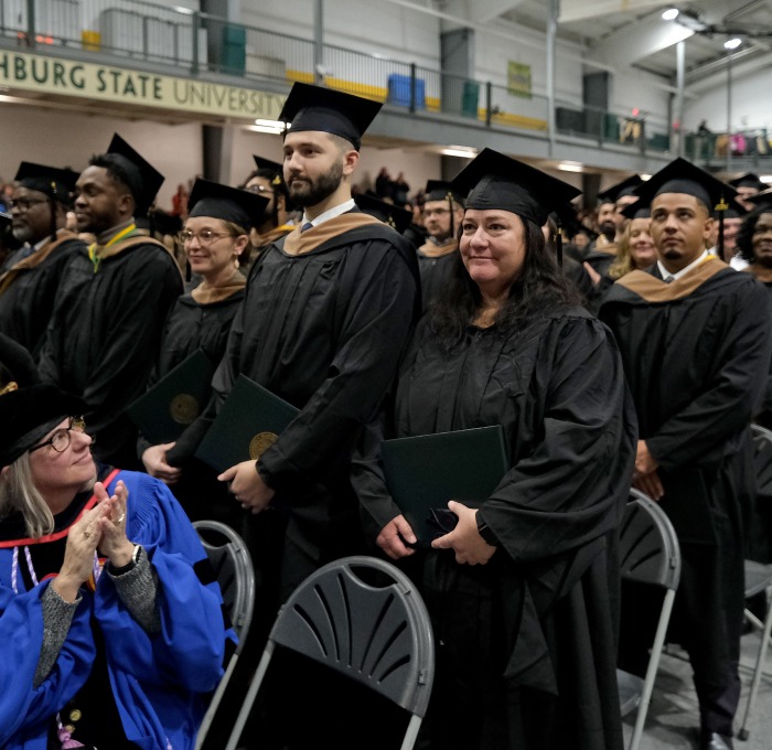 Grad students standing in rec center at commencement