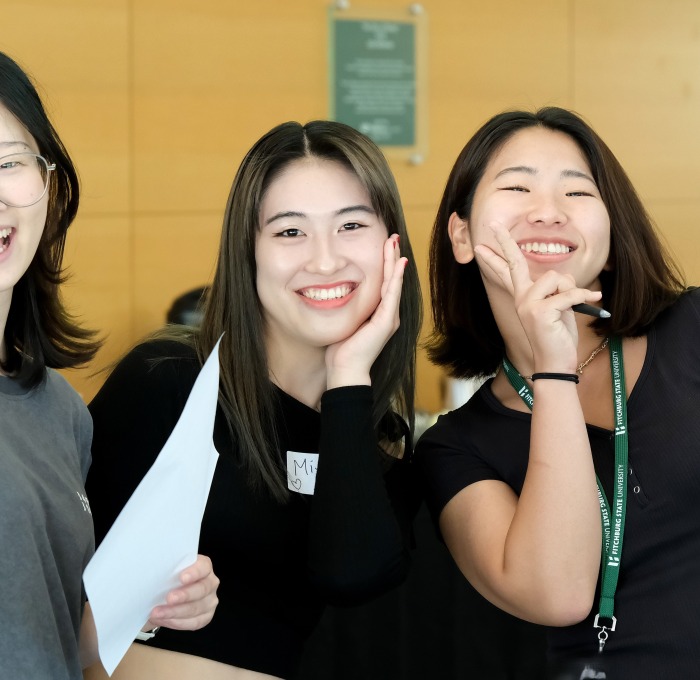 Smiling International Asian female students at orientation