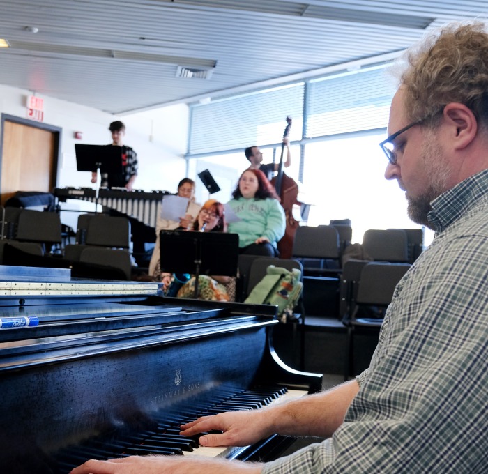 Teacher and students playing instruments in class