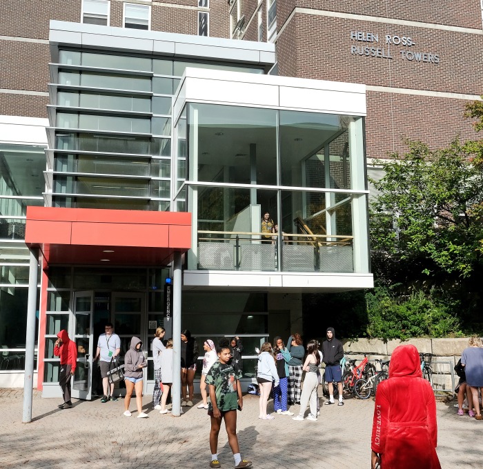 Student congregating outside Russell Towers during a fire drill