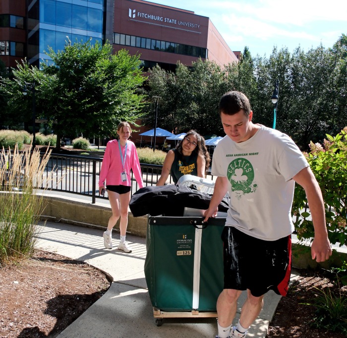 Students pushing bins and carrying gear moving into Aubuchon Hall