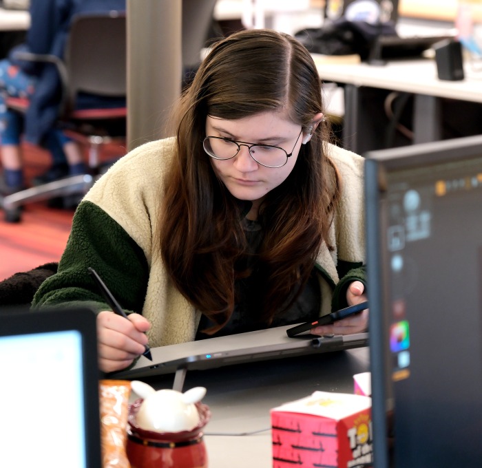 Female student drawing to design a game in the ideaLab
