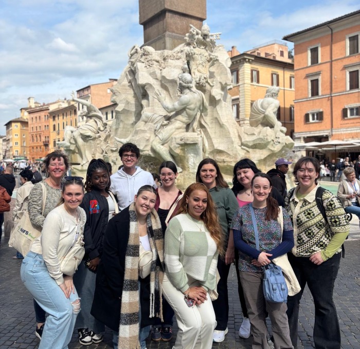 Study abroad group outside in front on monument in Italy