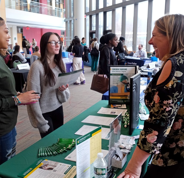 Students talking to SGOCE staff member at career fair