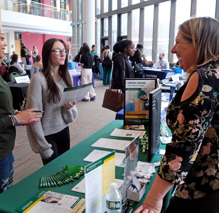 Students talking to SGOCE staff member at career fair