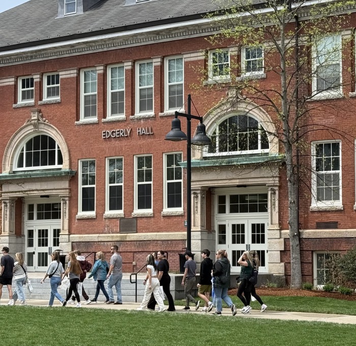 Large tour group walking on the quad past Edgerly Hall