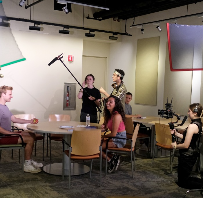 Students filming a movie with microphones, lights, cameras in Falcon Hub