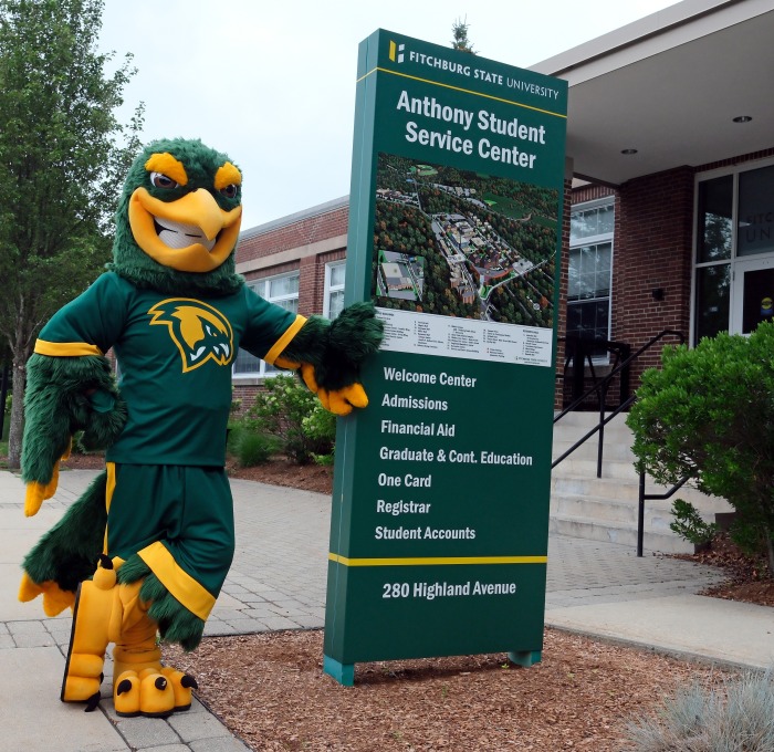 Freddy in front of Anthony Student Center with sign