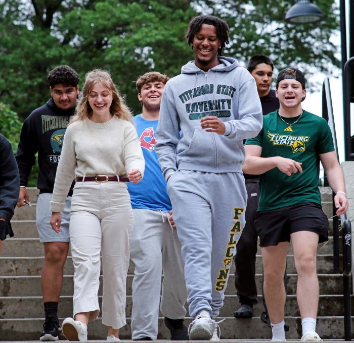 Smiling group of students walking down the stairs