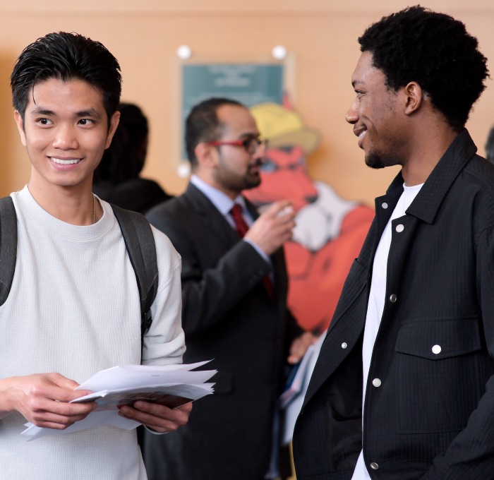Two male students in main lounge at Business Career Fair.