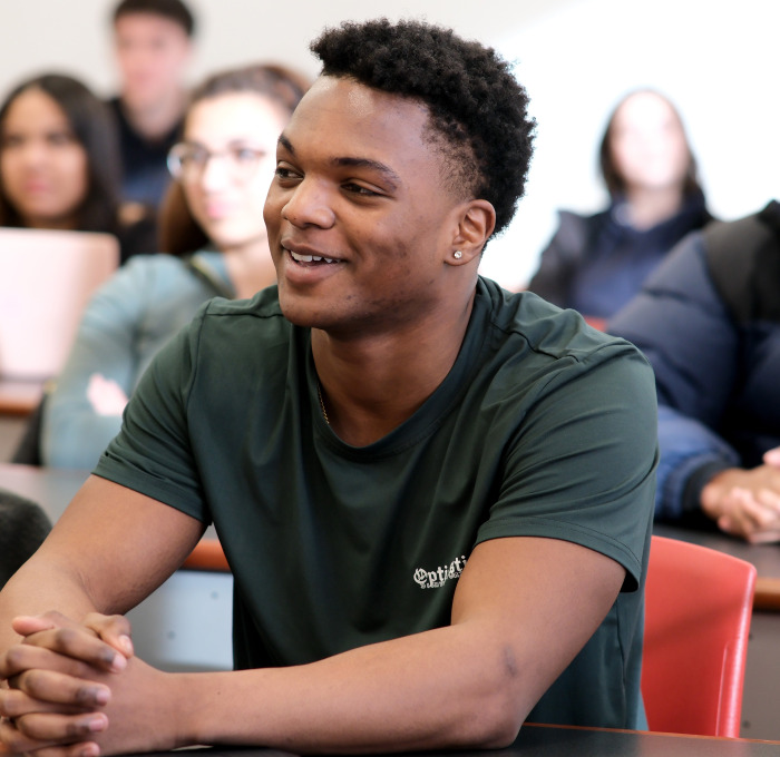 Students in the classroom at tables. 