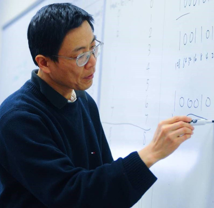 Brady Chen writing on whiteboard.