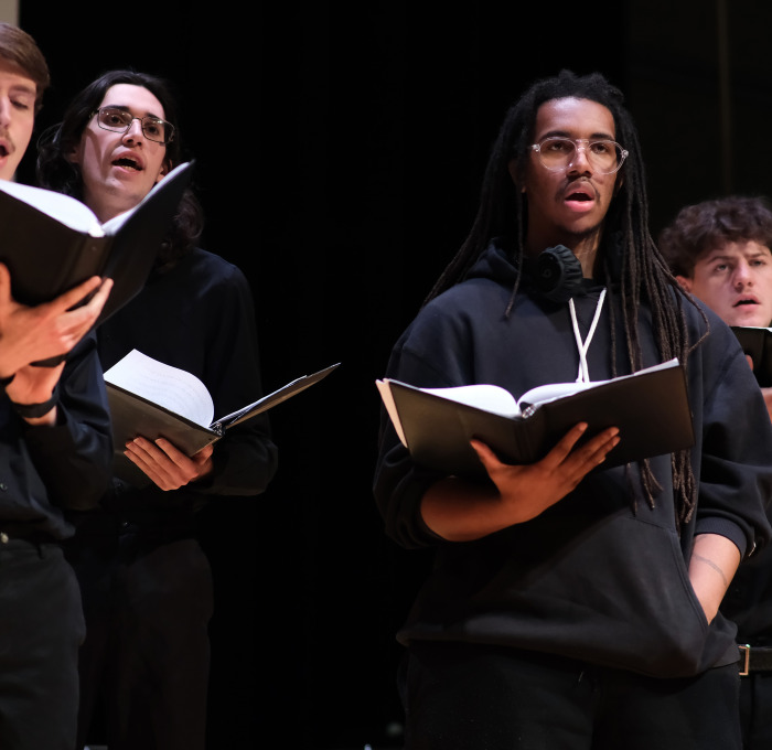 Male choir singers on stage at Music Mega Mix in Weston.