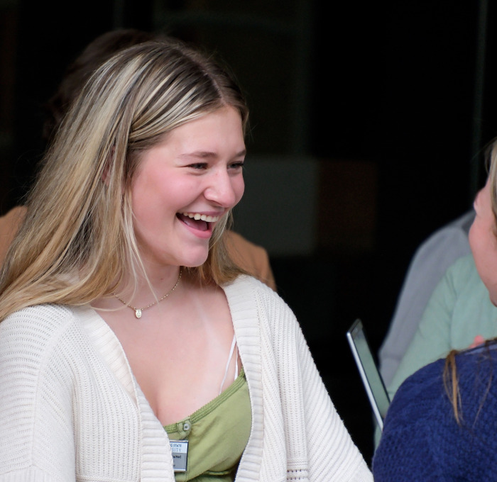 Students talking and smiling outside.