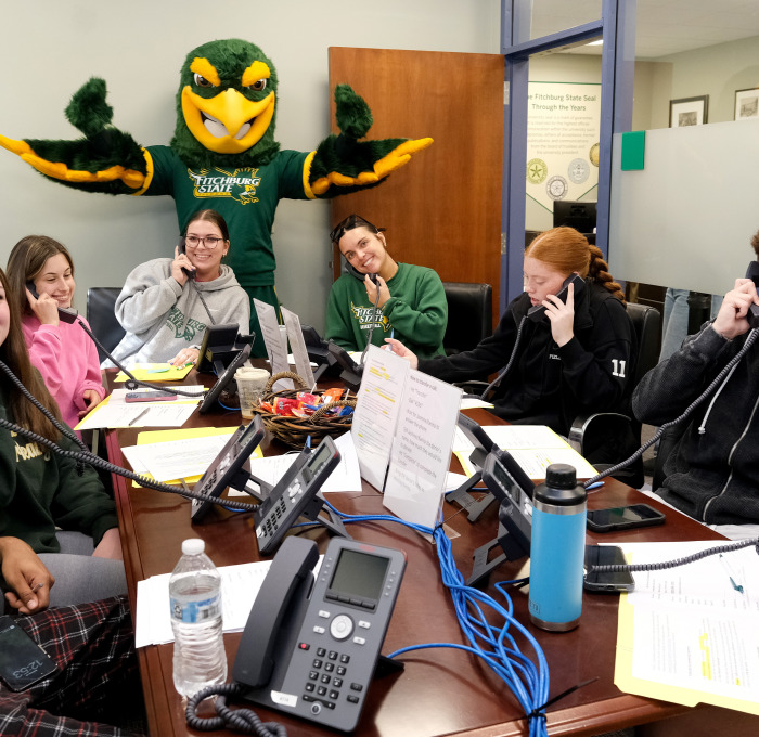 Freddy and sport team volunteers calling donors for Go Falcon Challenge.