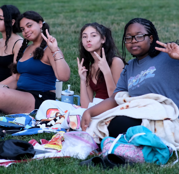 Students sitting on blanket on the quad.