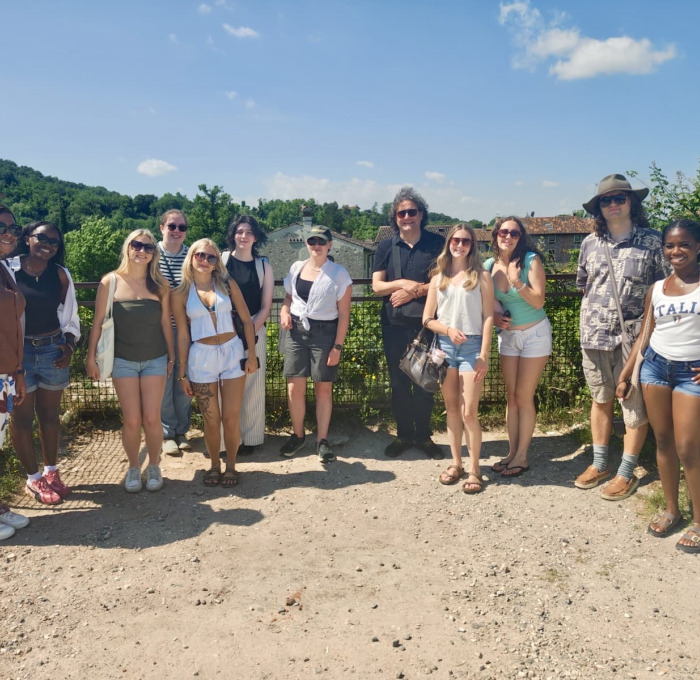 students and faculty posing outside in Verona