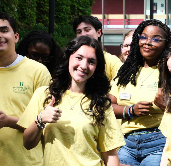 Orientation leaders smiling outside.
