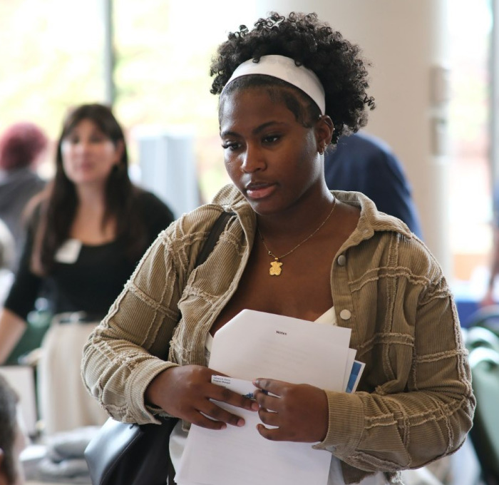 Female student at career fair in main lounge.