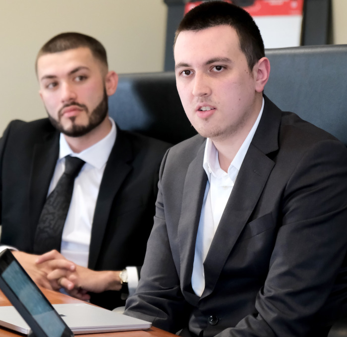 Professional business students at conference table.
