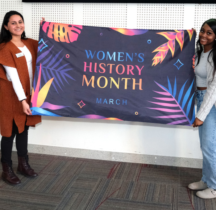 Krysta and Selma holding flag in Main Lounge.