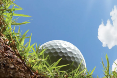 View looking out of ground with golf ball and sky in the background.