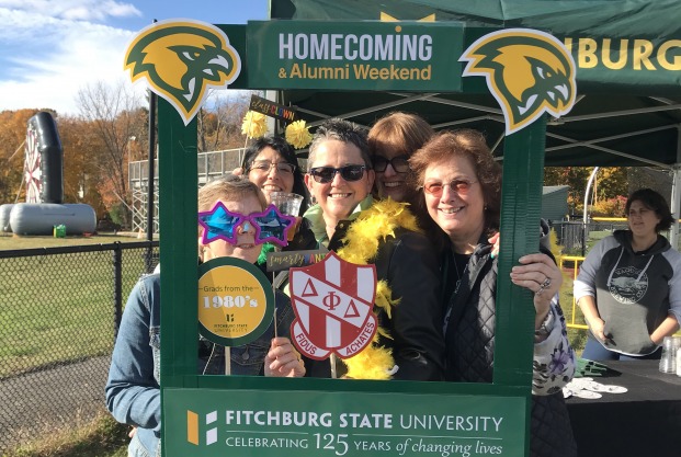 Alumni taking selfies at Homecoming football game