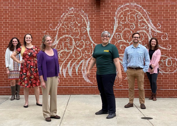 Academic Coaching and Tutoring Staff in front of chalk art on campus