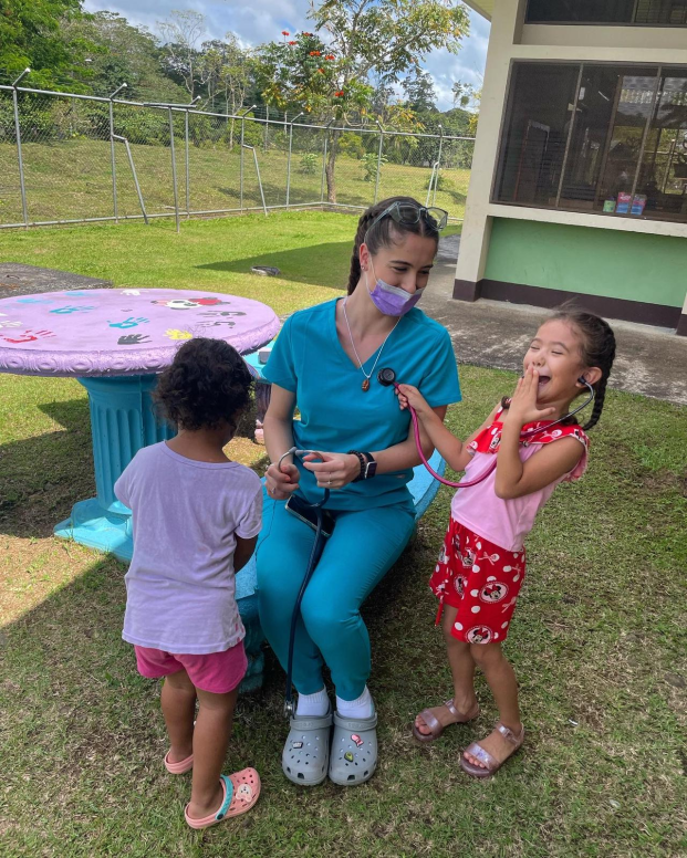 Nursing student Genevieve Casucci with children on a trip to Costa Rica