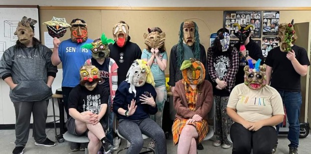 Students with masks on that they made in class