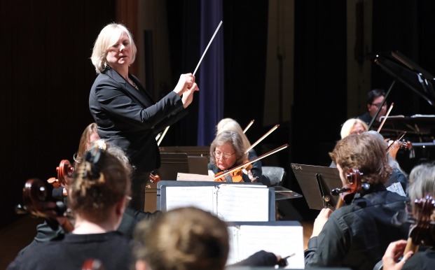 Hildy S conducting community orchestra in Weston