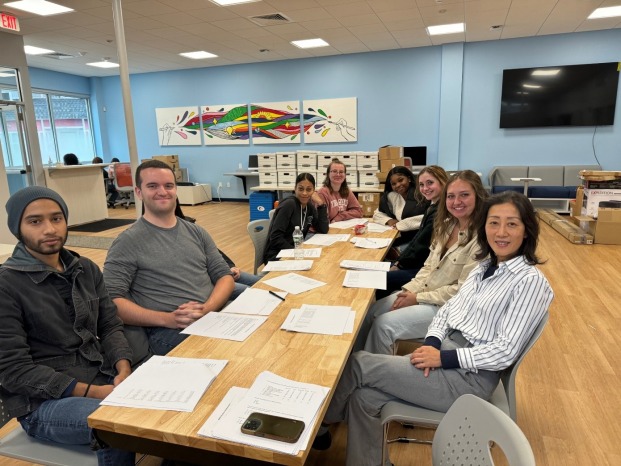 Jane Huang and students sitting at a table