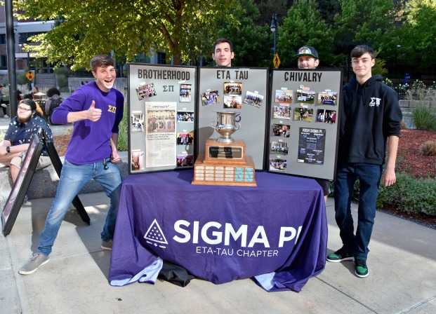 Brothers of Sigma Pi at a table at Meet the Greeks