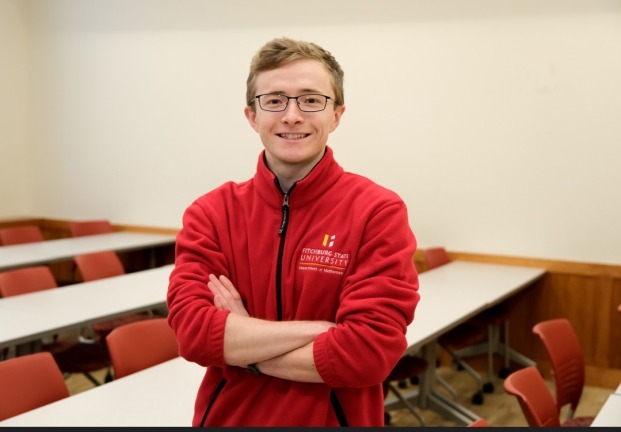 Cameron Davis poses with crossed arms in Percival classroom