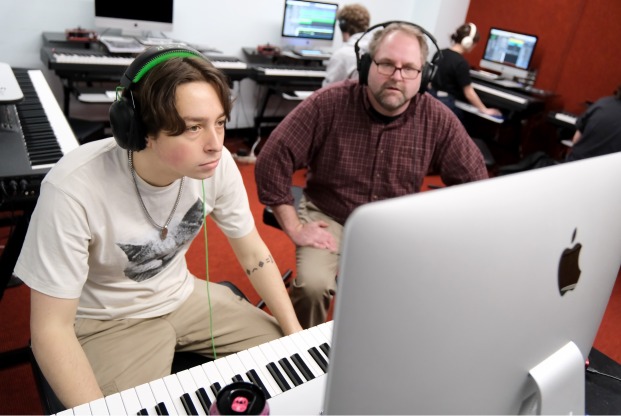 Justin Casinghino Music Professor and student working on keyboard with laptop