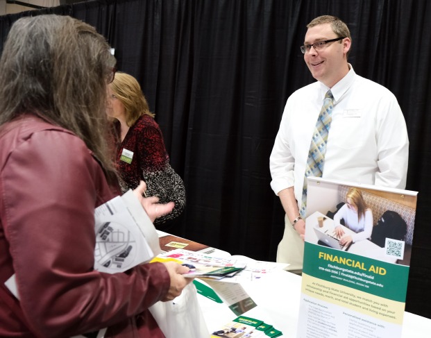 Financial aid staff talking to parent of student