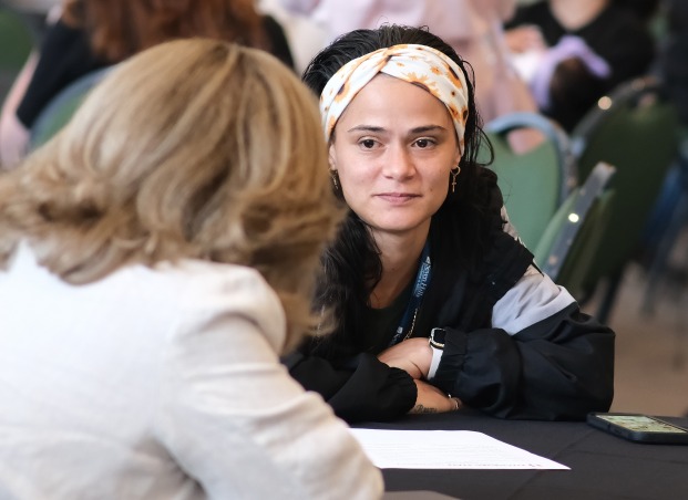 Student and advisor at table in main lounge