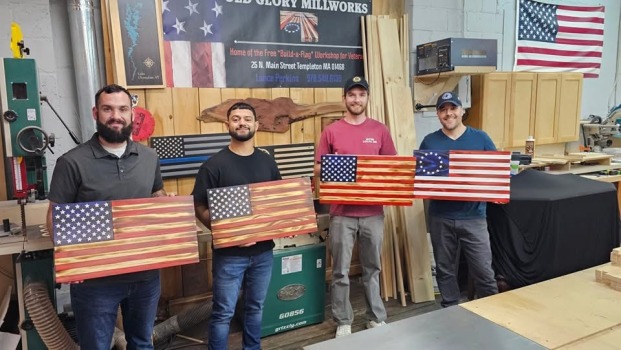 Group showing the flags they made at Old Glory Mill Works